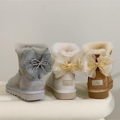 China Outdoor Student Women Snow Boots Wholesale Short Tube Warm Plush Bow Ribbon Fashion Metal Winter Fur Snow Boots for sale