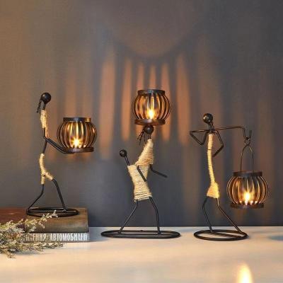 China Handmade Art Crafts Figurines Abstract Stick Candlestick Art Deco Nordic Metal Doll Lanterns Candle Holder Home Decoration Gift for sale