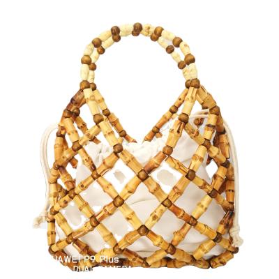 China Durable and practical and new beach rattan bamboo handheld bag fashion package craft hollow woven hot bag for sale