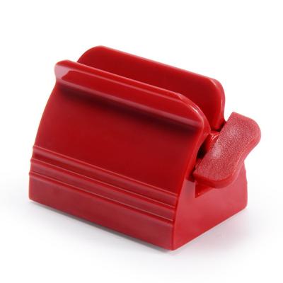 China Viable Free Shipping Red White Rolling Rack Bathroom Accessories Toothpaste Dispenser Squeezer for sale