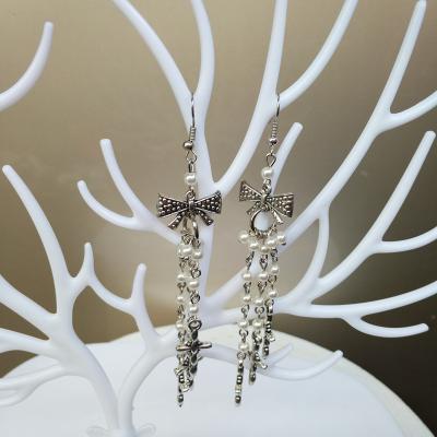 China 2022 Vintage Fashion Metal Bowknot Pearl Ear Hook Beaded Jewelry Wild Simple Cross Tassel Long Earrings for sale