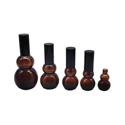 China Good Quality Calabash Shape Cosmetic Glass Bottle Brown Empty Essential Oil Bottle With Sprayer for sale