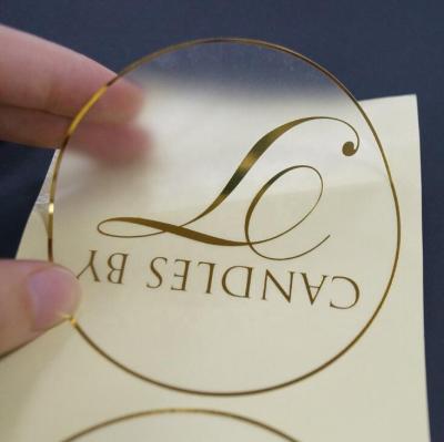 China Customized Printing Clear Stickers Waterproof Self Adhesive Logo Transparent Gold Foil Label for sale