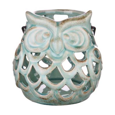 China Home Decoration 6 Inch Cavity Owl Design Essential Tealight Candle Blue White Ceramic Holders With Metal Handle For Home Decor for sale