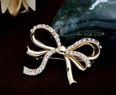 China High Quality Clothing Clip Bowknot Brooch Fixing Pin Hollow Resin Drill Anti Light Metal Bow Brooch For Women for sale