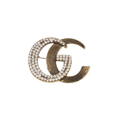 China Beautiful retro brand style French style Gg LOGO simple brooch with rhinestones, accessories and creative brooch for sale