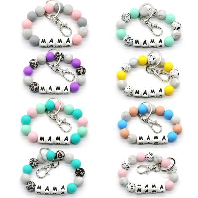 China Fashionable Food Grade Silicone Beads Key Chain Bracelet Letter Wrist Fringe Disc Keychain Pendant Keychain for sale