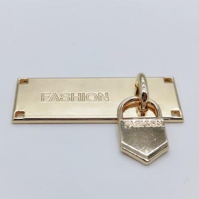 China Sustainable High Quality Custom Metal Letter Logo With Sewing Hole Plated Engraved Metal Label For Garment for sale