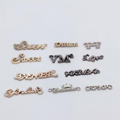 China Viable Customized Letter Form Zinc Alloy Metal Label Plated Rhinestone Alphabet Brand Logo Label for sale