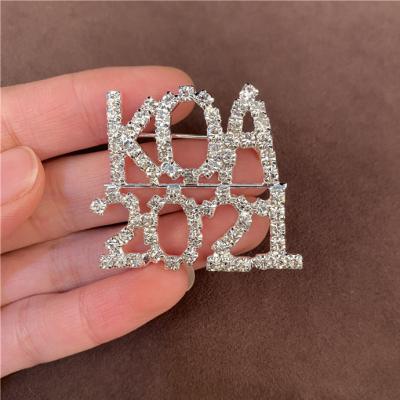 China Custom Number Brass Pin Rhinestone Crystal Brooch Sash Pin for sale