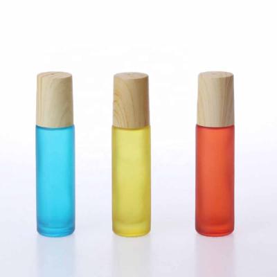 China Ball Cosmetic Bottle With Wooden Grain Cover 10ml Transparent Brown Blue Pearl Walking Bottle for sale