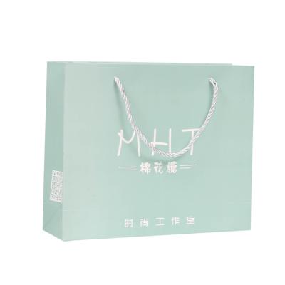 China Recycled Materials Adjust Bottom Paper Bag White Flower Handle Cosmetics Gift Shopping Bag for sale