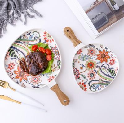 China Sustainable Design Table Fruit Dishes Creative Flower Glazed Steak Ceramic Dish With Wooden Handle for sale