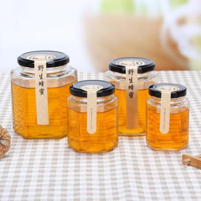 China Cheap Household Products Hexagon Round Clear Honey Cream Glass Bottle Jar Storage With Lid for sale