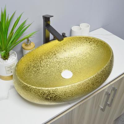 China Easy Clean Luxury Ceramic Oval Shape Vessel Bathroom Sink Basin Style Basin Countertop Gold Basin for sale