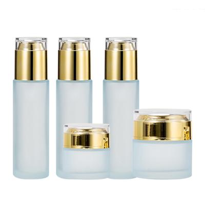 China Transparent Frosted Glass Skin Care Products Spray Bottle With Gold Pump Emulsion Cream Bottle Cosmetic Bottle for sale