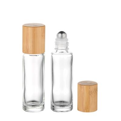 China 10ml 15ml Cosmetic Essential Oil Clear Refillable Glass Roll On Bottle With Steel Roller Ball And Bamboo Lid for sale