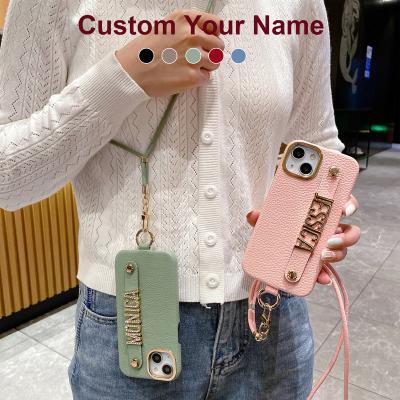 China Shockproof Cross - Body Personalize Name Lanyard PU Lychee Leather Phone Case For iPhone 14 Pro Max Plus Diamond Metal Letter Cover for sale