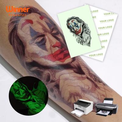 China 100 Sheets Temporary Fast Delivery Package RED IN DARK Waterproof Tattoo Sticker Paper For Skin for sale