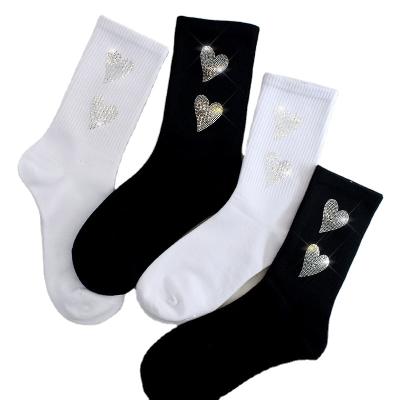 China Sporty popular sweat-wicking cotton solid color mid tube jars polyester black white crew socks for sale