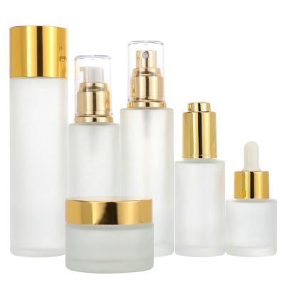 China High Quality Blue Cosmetic Glass Bottle Set Skin Care Packaging Custom Cosmetics Glass Cream Lotion Bottles And Jars With Milk White Cap for sale