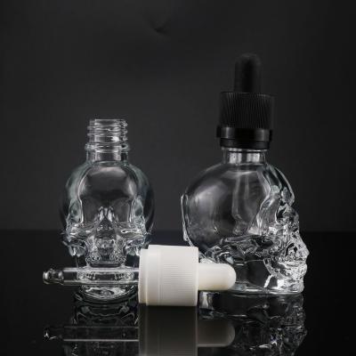 China High Quality Unique Fancy Design Shape Spirit Glass Bottle 30ml Skull Bottle For Skin Care for sale