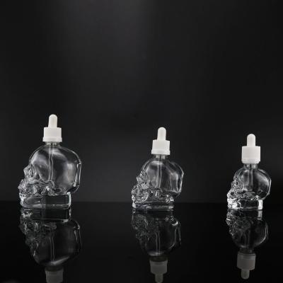 China 30ml 60ml 120ml high quality transparent special shape skull glass bottle with dropperl lid for sale