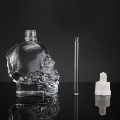 China High Quality 60ml Skull Shaped Glass Dropper Bottle Lid For Cosmetic Packaging for sale