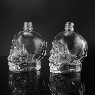 China High quality 30ml skull shape empty glass bottle, creative design glass material container on hot sale for sale