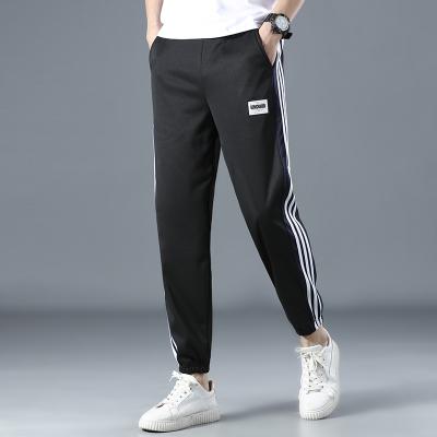 China 2021 summer new young men's fashion trend stretch loose men's spring/loose sportswear pants QUICK DRY pants for sale