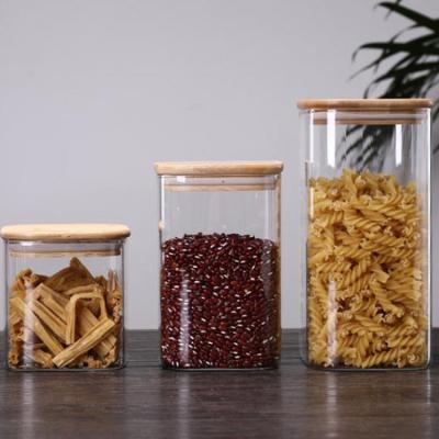 China Custom Environmental Square Freshness Storage Glass Jar Containers With Lid Wood Borosilicate Stackable Airtight Glass Storage Canister for sale