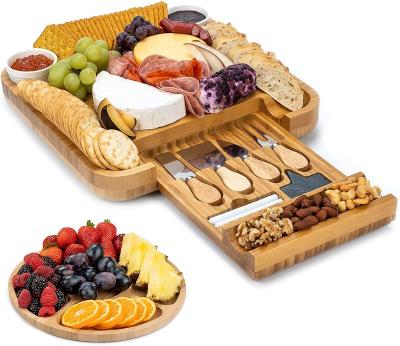 China Sustainable cheese board and knife set bamboo Charcuterie board with magnetic slide-out drawer and 2 ceramic bowls with fruit serving tray for sale