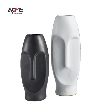 China Art Deco Nordic High Grade Matte Black And White Lively Face Shape Porcelain Vase Luxury Customized Ceramic Vases for sale