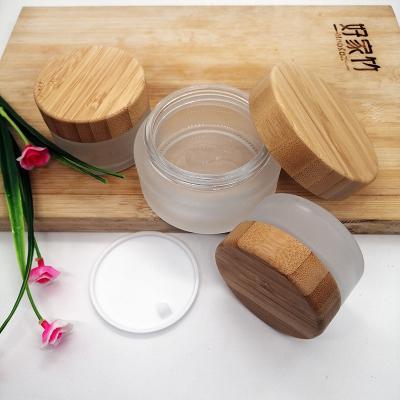 China 2021 New Popularity 30g 50g 100g Personal Care Frosted Wooden Bamboo Glass Jar Small Lid Cap Cosmetic Containers for sale