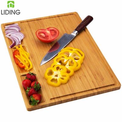 China Sustainable Extra Large Bamboo Cheese Cutting Board with 3 Integrated Dividers and Juice Grooves for sale