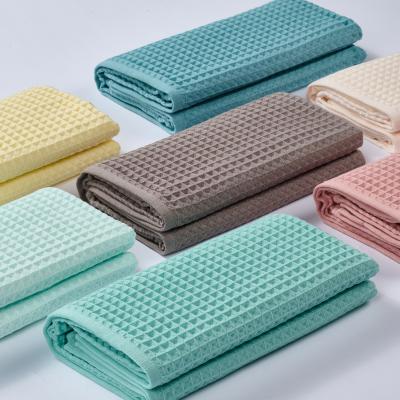 China OEM ODM Rectangle Solid Color QUICK DRY Organic Based Wholesale Cut Stack Antimicrobial Cotton Waffle Hotel Bath Adult Beach Towel for sale