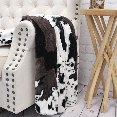 China Single Sided Warm Comfortable Lightweight Travel Faux Fur Fleece Cow Double Sided Print Throw Sofa Blanket for sale