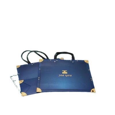 China Custom Logo Promotion Folding Pattern Handbag Packaging Boxes With Ribbon Handle for sale