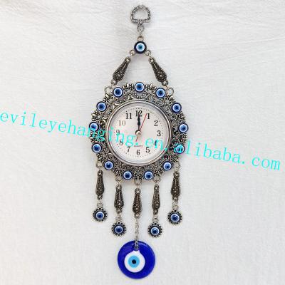 China Antique Imitation Evil Eye Blue Bead Around Clock Wall Hanging Decoration with Handmade Evil Eye Glass Bead for Home Decor Zinc Alloy for sale