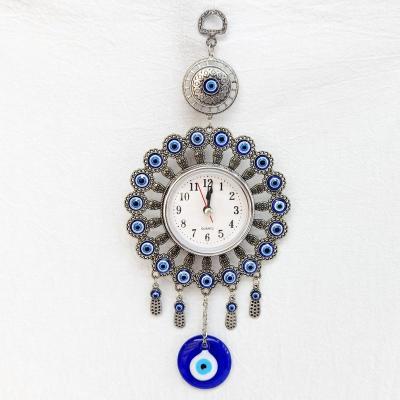 China Antique Evil Eye Imitation Pearl Around Clock Wall Hanging Decoration with Glass Evil Eye for Metal Souvenir Decor Home Clock for sale