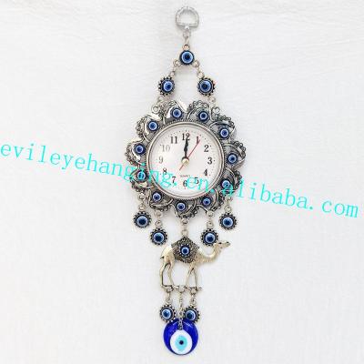 China Antique Sign The Camel Clock Wall Hanging Decoration With Evil Eye Glass Bead For Metal Souvenir Home Decor Decorative Clock for sale