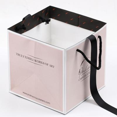 China Custom Fashion Logo Printing Luxury Square Pink Materials Recycled Shopping Gift Retail Paper Bags With Ribbon Handle for sale