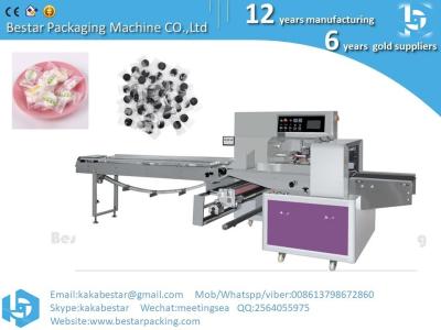 China Small food packing machine Compress face mask packing machine,Flow packing machine with automatic feeder for sale