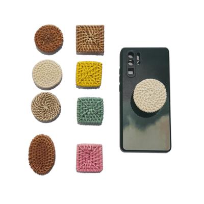 China Wholesale Adjustable Handmade Cushion Foldable Popular Phone Holder Sockets With Glue Rattan Mobile Phone Holders for sale