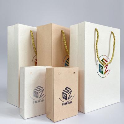 China Recycled Materials Custom Printing Logo Christmas Promotional Packaging Gift Bags Paper Bag With Handle for sale