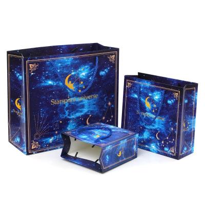 China Luxury Dark Blue Starry Starry Clothing Cosmetics Jewelry Materials Sky Kraft Paper Gift Shopping Bags and Business Box Recycled Heavy Paper Bags for sale