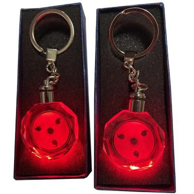 China New fashion ceremonial fashion golden age red light keychains sasuke sasuke sharingan wholesale cartoon samsara eye key chain key holder for sale