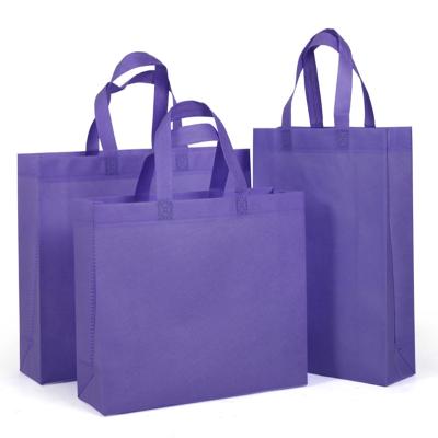 China Environmental protection purple non woven saree bags non woven bags fabric bags wovenraw material for non woven bags for sale