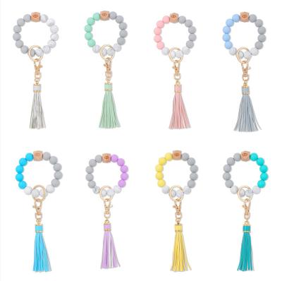 China Plastic Women's Keychains Monogram Disc Key Chain Ring Holder Silicone Bead Tassel Wooden Empty Bracelet Bangle for sale