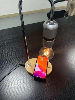 China wooden base magnetic levitation lamp bulb light with wireless charging for iphone cellphone for sale